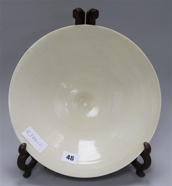 A Chinese cream glazed bowl on stand